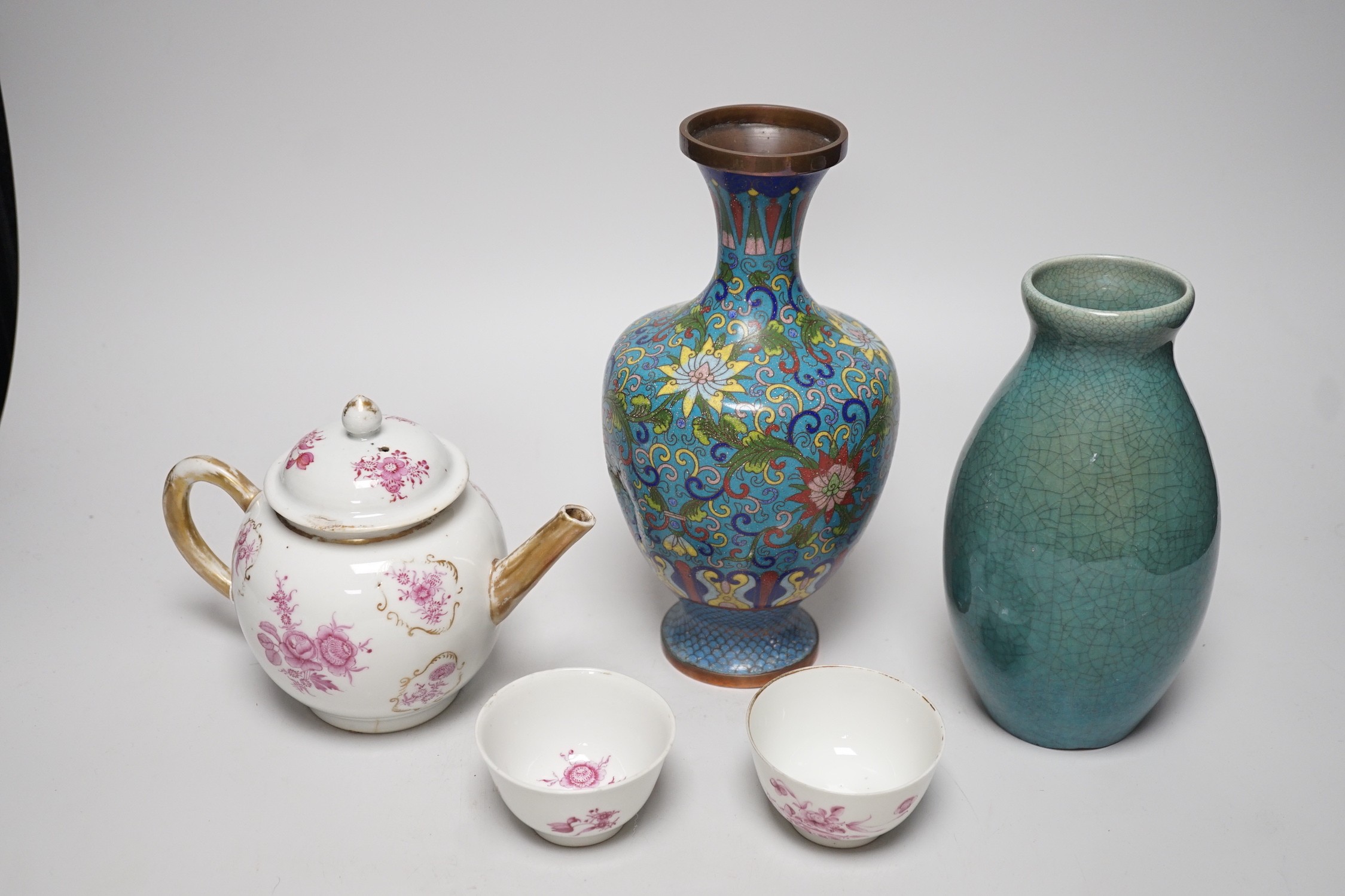 A selection of Oriental ceramics, to include a Chinese pink enamelled export teapot and matching tea bowls, a cloisonné blue ground vase, and a blue Japanese crackle glaze, (5). Tallest 23cm